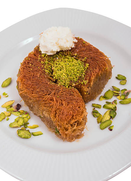 kadayif dessert with pistachio and natural milk cream stock photo