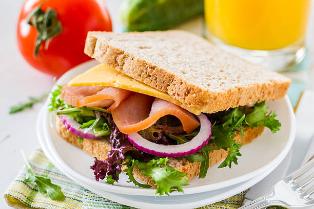 istock Sandwich with ham, cheese and salad on white plate 538529409