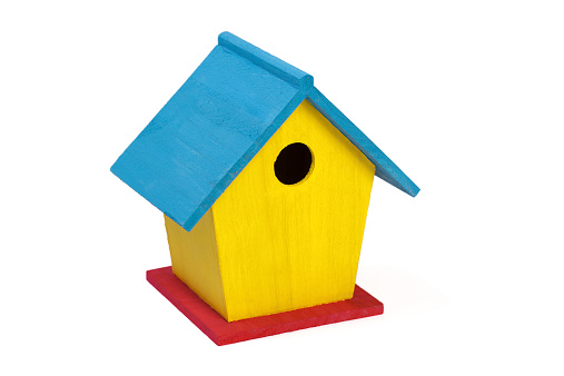A small painted wooden birdhouse isolated on a white background