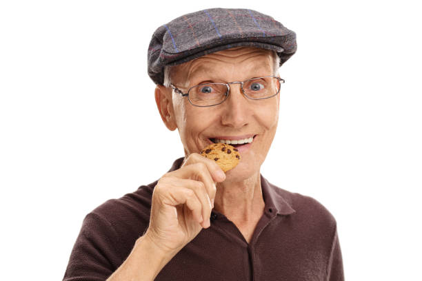 istock Mature man eating a chocolate chip cookie 538558064