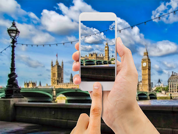 istock tourist holds up camera mobile at big ben 538559486