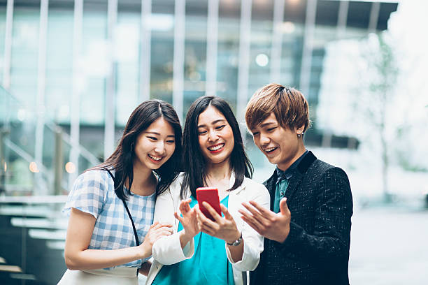 Young asian friends making selfie on street