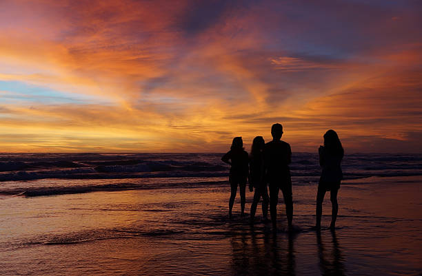 istock Young people enjoying the sunset at the beach 538565785
