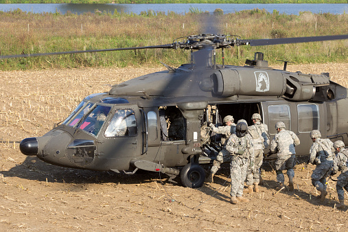 Grave, Netherlands - September 17, 2014: Soldiers of the 82nd Airborne Division enter a Black Hawk helicopter at the Operation Market Garden memorial. Market Garden was a large Allied operation in 1944.