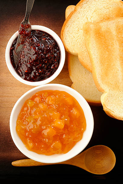 istock fruit jam and toast on wooden background 538566447