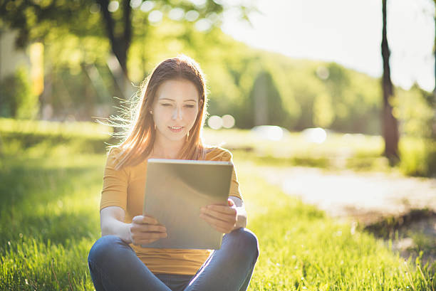 istock young woman with tablet in summer 538567186