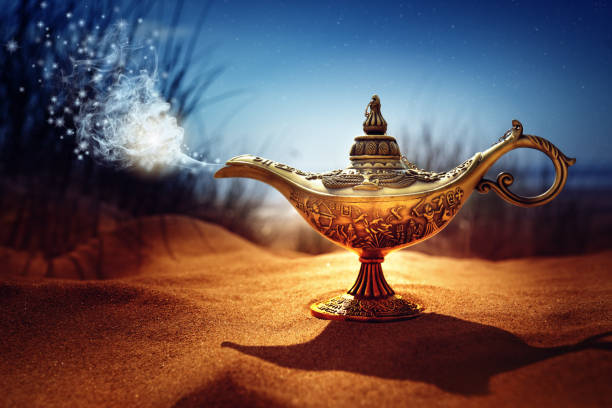 Magic Aladdins Genie lamp Magic lamp in the desert from the story of Aladdin with Genie appearing in blue smoke concept for wishing, luck and magic old oil lamp stock pictures, royalty-free photos & images