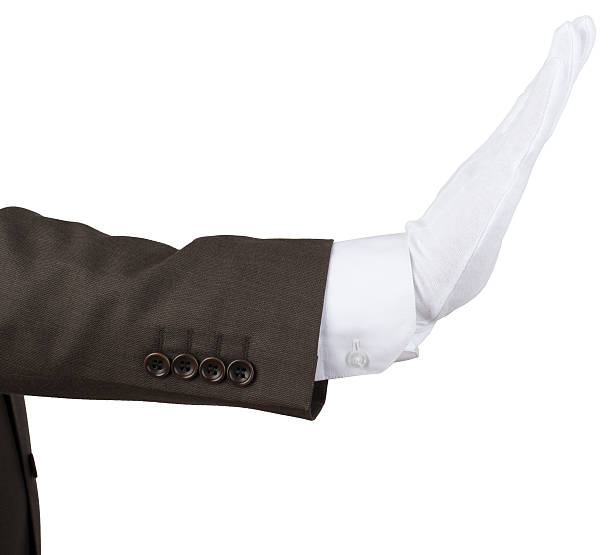 istock Mans hand in white glove showing stop gesture 538569532