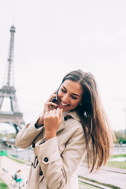 istock Cheerful young woman talking on smart phone in Paris 538570534