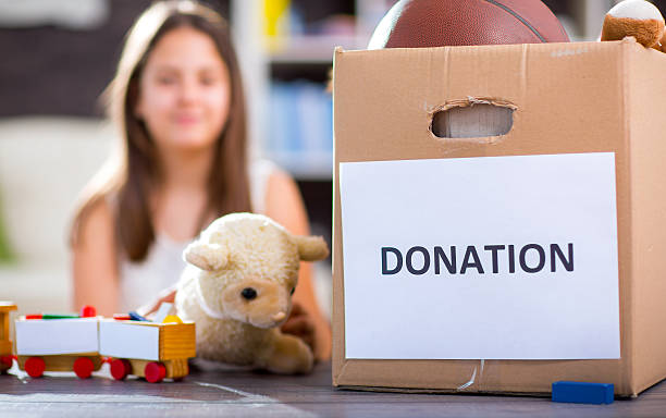 istock Girl taking donation box full with stuff for donate 538571020