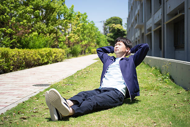 istock Man who does a sit-up on a lawn 538571198