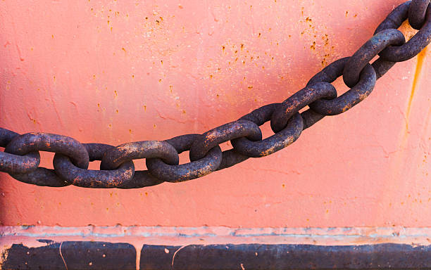 istock Part of an old rusted chain on a riverside 538573496
