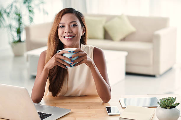 Enjoying hot chocolate Portrait of beautiful Filipino girl holding cup of hot chocolate hot filipina women stock pictures, royalty-free photos & images