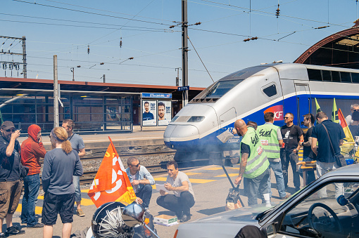 Strasbourg, France - June 6, 2016: Protesters making barbeque outside the Gare de Strasbourg, during a demonstration by railway workers of French state rail operator SNCF, as part of a strike to defend their work conditions.