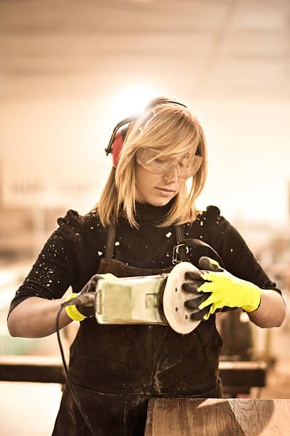 istock Blonde woman with power sander 538576094