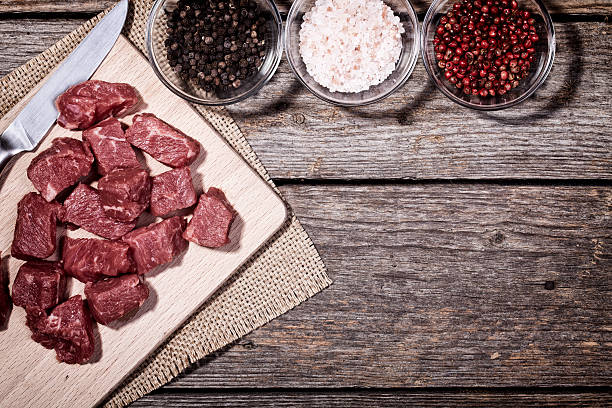 istock Cut Beef Meat on Wood Table with Pepper and Salt 538580446