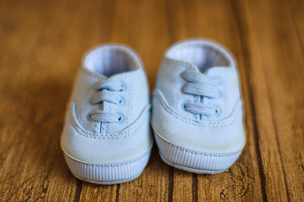 Cute blue baby shoes on the sofa