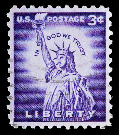 UNITED STATES OF AMERICA - CIRCA 1954: A used postage stamp printed in United States shows the Statue of Liberty on a violet background, circa 1954