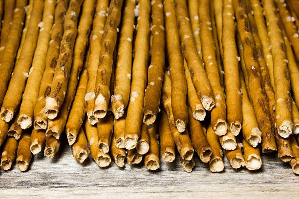 istock Bread sticks with salt on wooden background 538585164