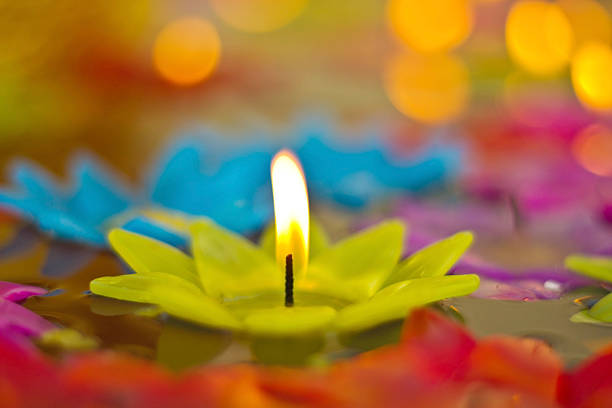 istock One light candle burning brightly in the black background 538585880