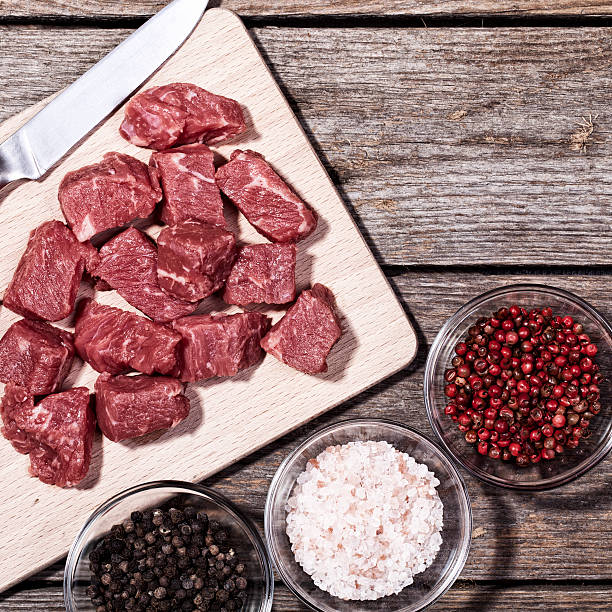 istock Cut Beef Meat on Wood Table with Pepper and Salt 538587352
