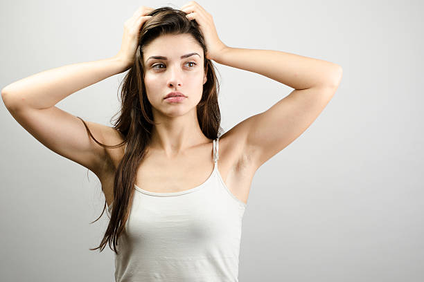 istock Young sad woman holding head and thinking 538588116