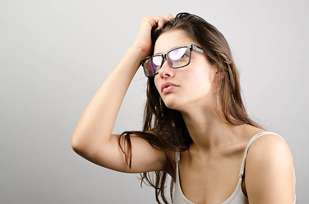 istock Young sad woman holding head and thinking 538588436