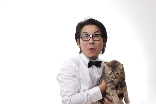 The Asian man with glasses holding cat.