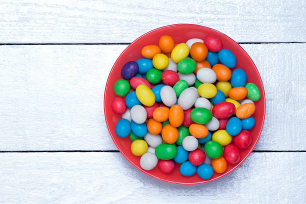 istock plate with colorful candy on a wooden surface 538592388