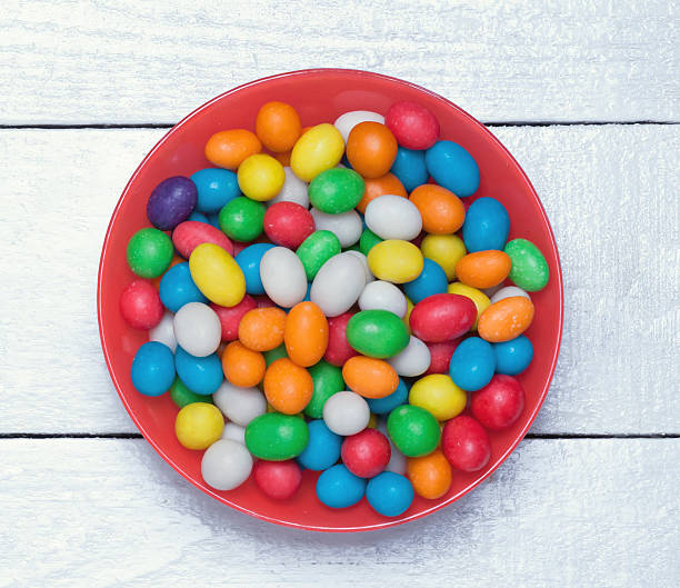 istock plate with colorful candy on a wooden surface. 538592430