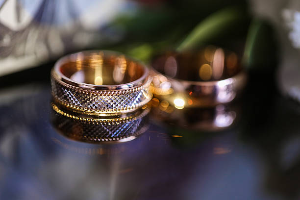 istock wedding rings on the glass table in black and white 538595530