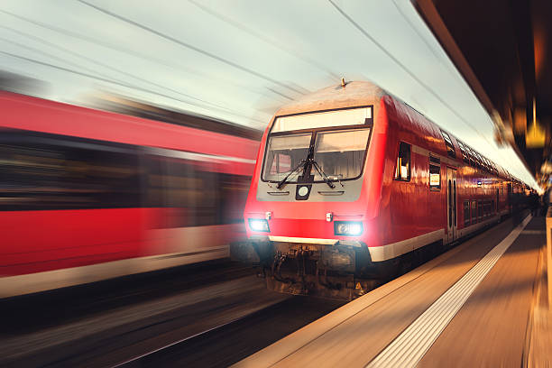 istock Beautiful railway station with modern red commuter train at sunset 538597602