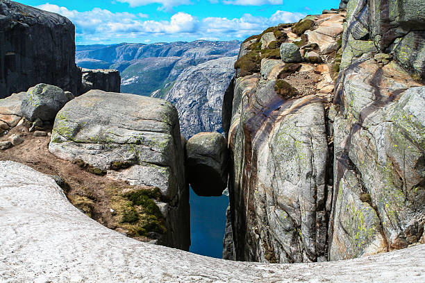 Close view of the Kjeragbolten above the Lysefjorden Close view of the famous boulder Kjeragbolten above the Lysefjorden on the mountain Kjerag in Forsand municipality in Rogaland county, Norway. ryfylke stock pictures, royalty-free photos & images