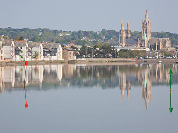 Reflections in the river at Truro The nineteenth century cathedral, modern riverside housing and marker posts for shipping all reflected in the Truro river at high tide. Truro is Cornwall's county town and the UK's most southerly city ebb and flow stock pictures, royalty-free photos & images