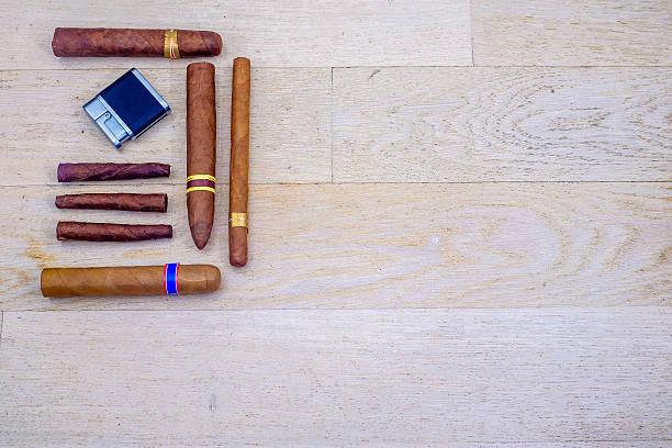 istock Cuban cigars and a lighter on a wooden floor 538601232