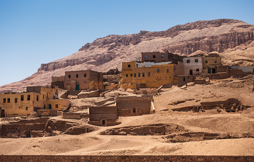 The old, ruined houses among cliffs and mountains of the desert of Egypt. Luxor, city of the dead (the West Bank)