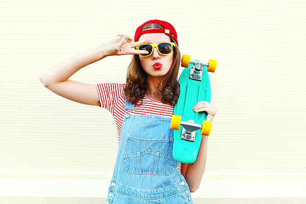 istock Pretty cool woman with skateboard having fun over white background 538603880