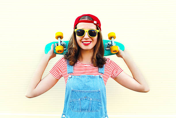 istock Pretty cool smiling woman with skateboard over white background 538603970
