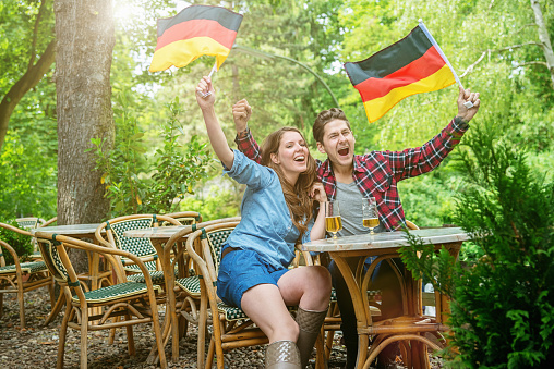 German Fan Couple Supporting Soccer Team in Beer Garden