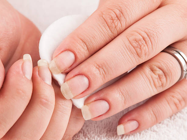 istock Woman using nail remover, making manicure herself 538605874