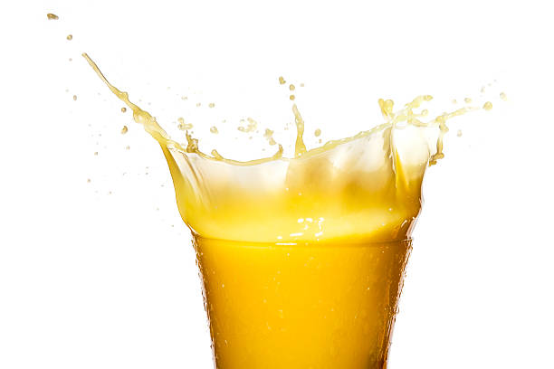 Orange juice. Splash in glass. Isolated on white