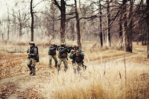 istock soldiers with guns on the field 538616061