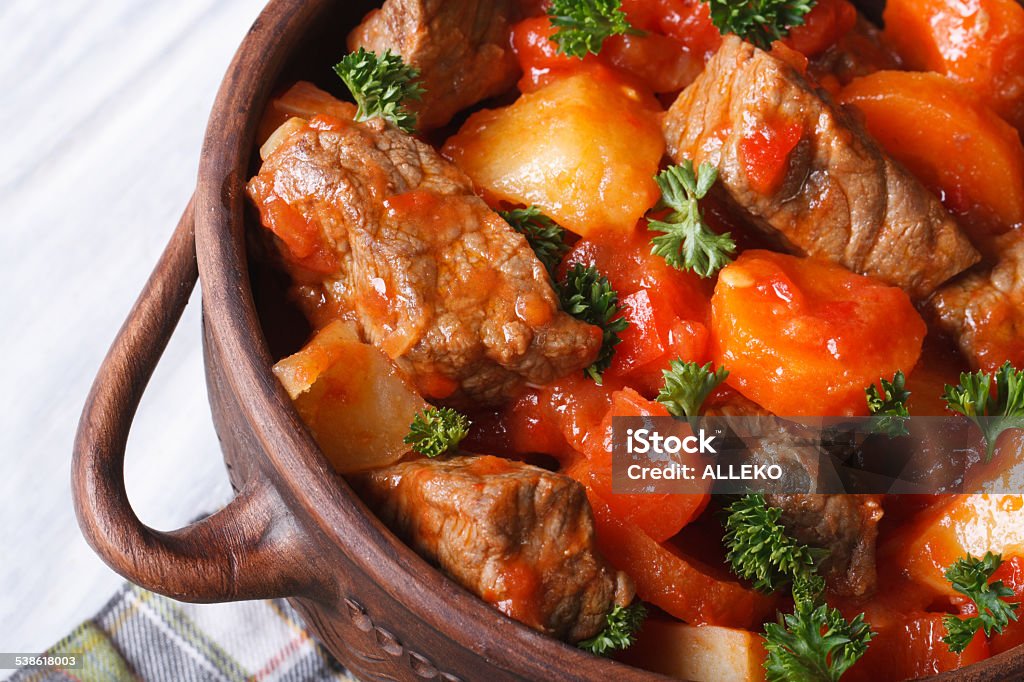 stew with tomato sauce and vegetables macro top view stew in tomato sauce with vegetables in a pot macro. horizontal top view 2015 Stock Photo