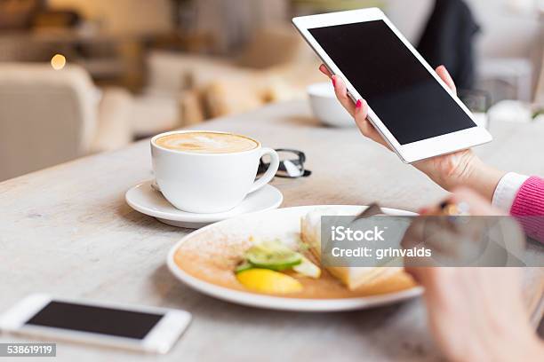 Woman Using Tablet Computer In Cafe Stock Photo - Download Image Now - E-Reader, 2015, Adult