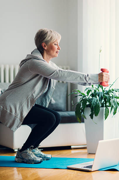 Mature Woman Exercising At Home.