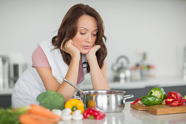 istock Serious woman preparing food in kitchen 538620311