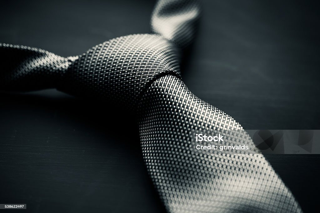 Fifty Shades of Grey theme Soft focus photo of grey man's tie on dark background in the style of Fifty Shades of Grey. Necktie Stock Photo