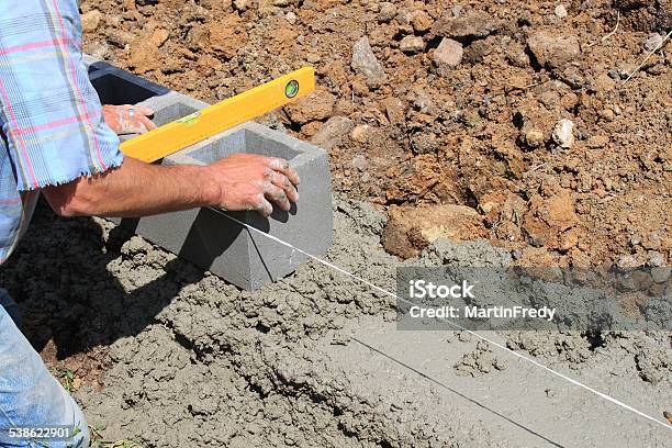 Bricklayer Builds A Wall Stock Photo - Download Image Now - 2015, Adult, Angle