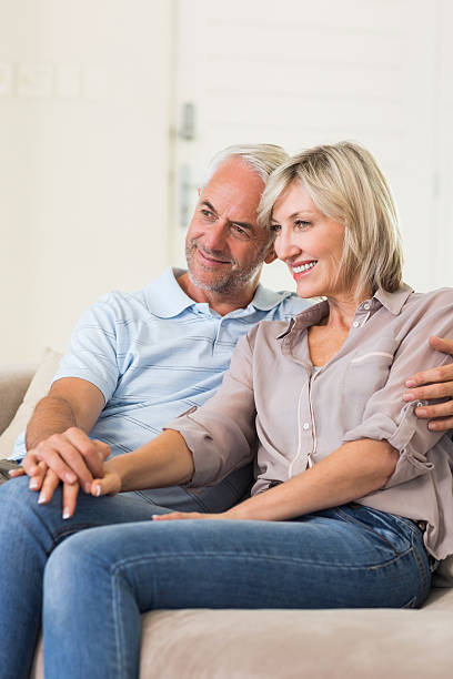 istock Smiling mature couple sitting on sofa 538623283