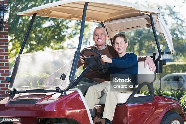 Teenage Boy With Father In Golf Cart Stock Photo - Download Image Now - Golf Cart, House, Family